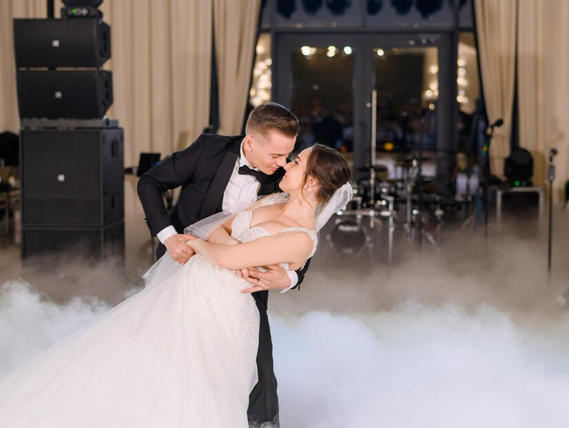handsome-groom-holding-bride-while-dancing-wedding-dance_8353-12359
